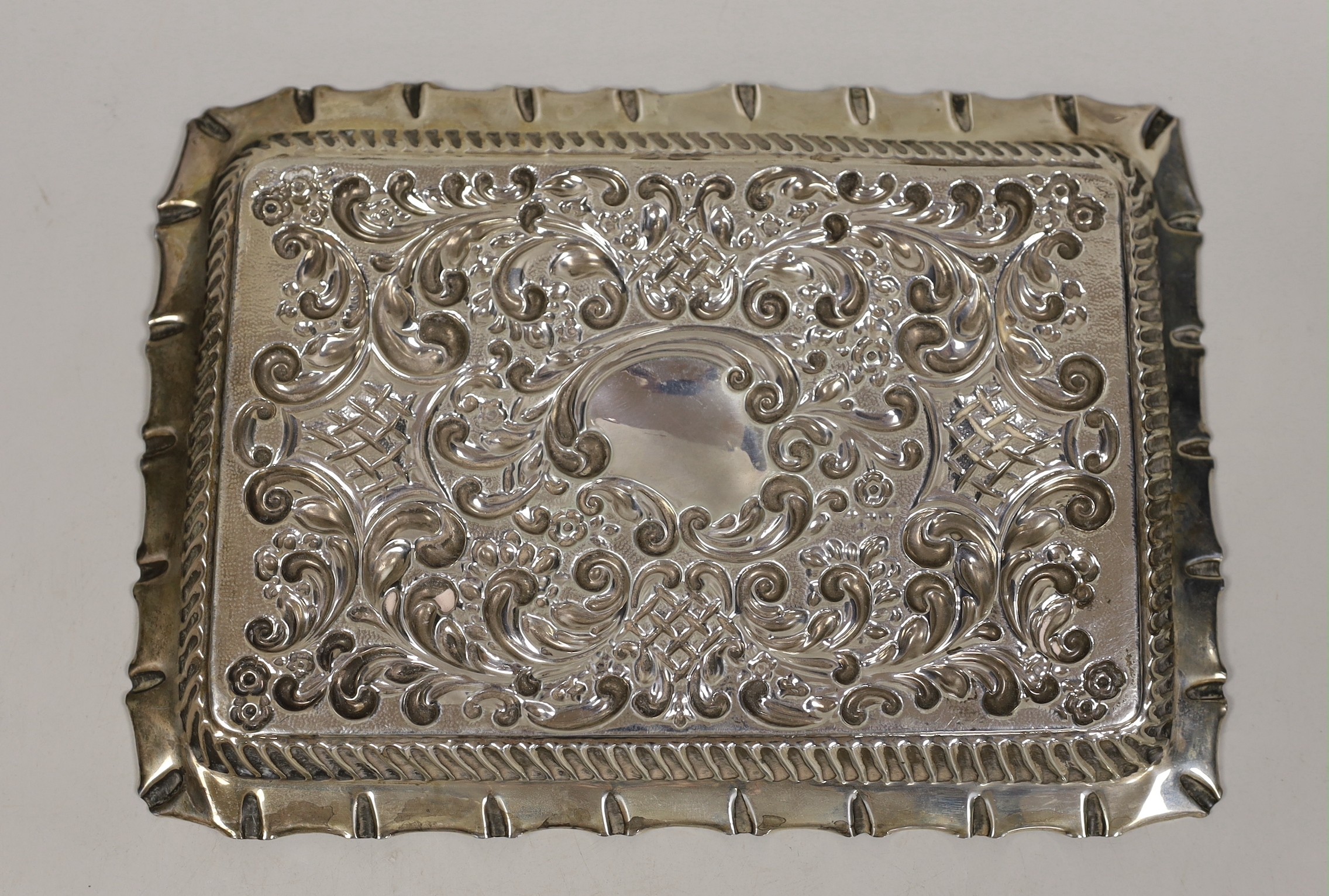 An Edwardian? repousse silver dressing table tray, maker, William Davenport, Birmingham, circa 1905, 27.2cm, 8.7oz.
